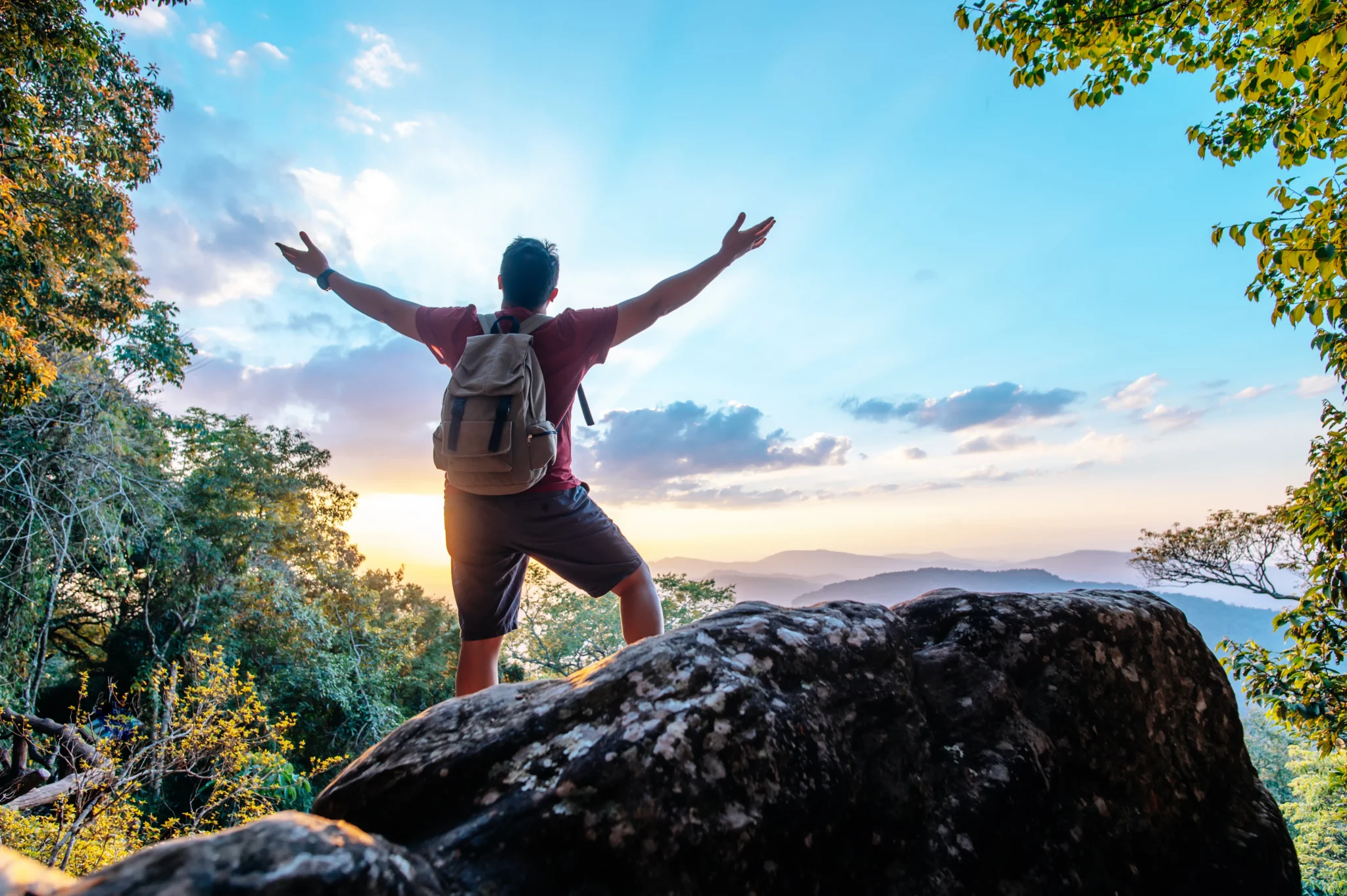 rear-view-back-young-asian-hiking-man-standing-riseup-hands-with-happy-peak-rocky-mountain-copy-space